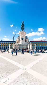 Vibrant view of Praça do Comércio in Lisbon showcasing a prominent equestrian statue under a clear blue sky.