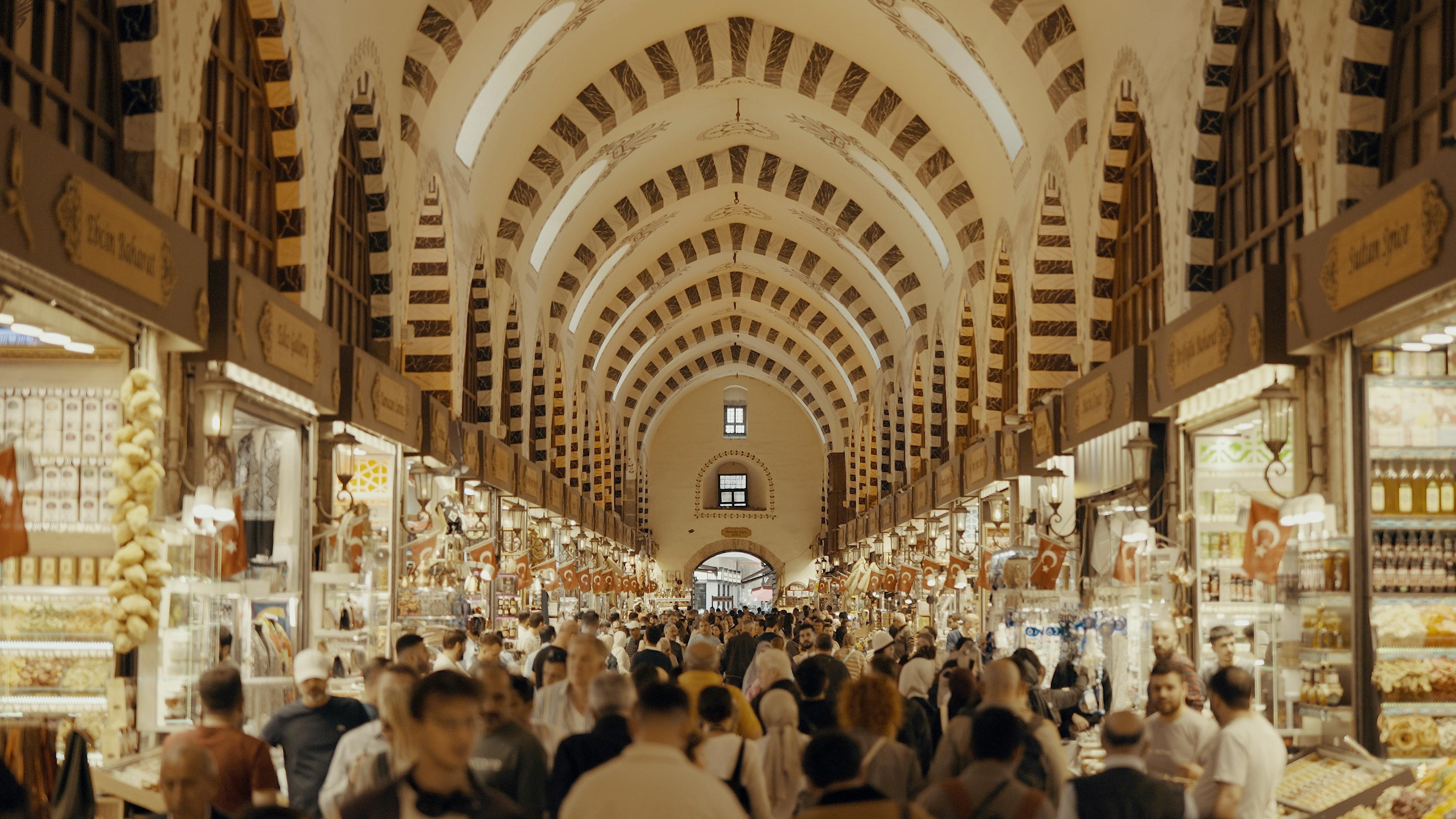 a crowded market with people walking through it