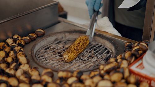 Free Street food vendor roasting chestnuts and corn in Istanbul. Stock Photo