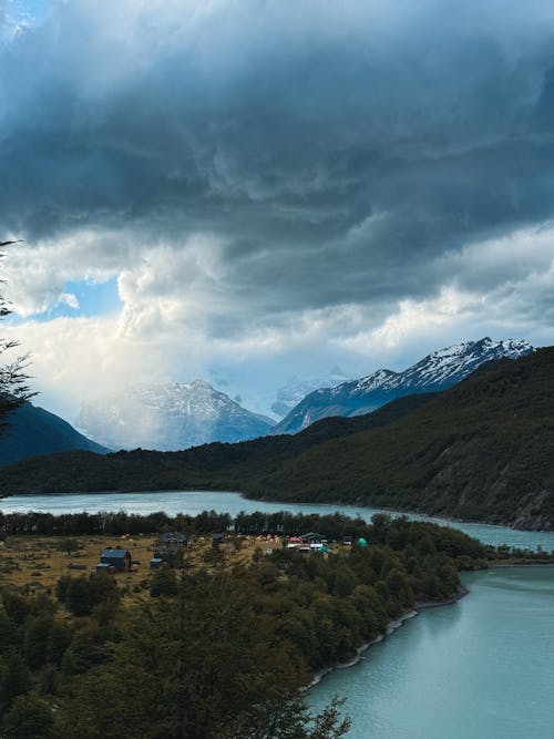 A view of a river and mountains under a cloudy sky