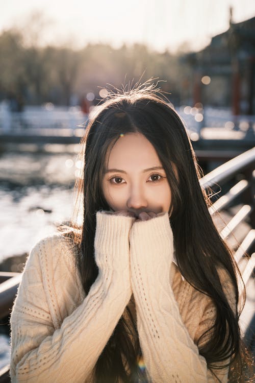 Free A woman in a sweater and scarf covering her face Stock Photo