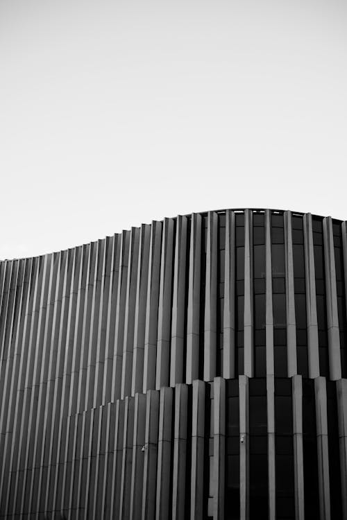 Black and white photo of a building with a black and white sky