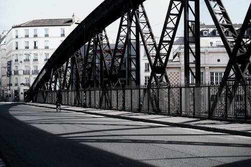 A person is walking on a bridge in the city