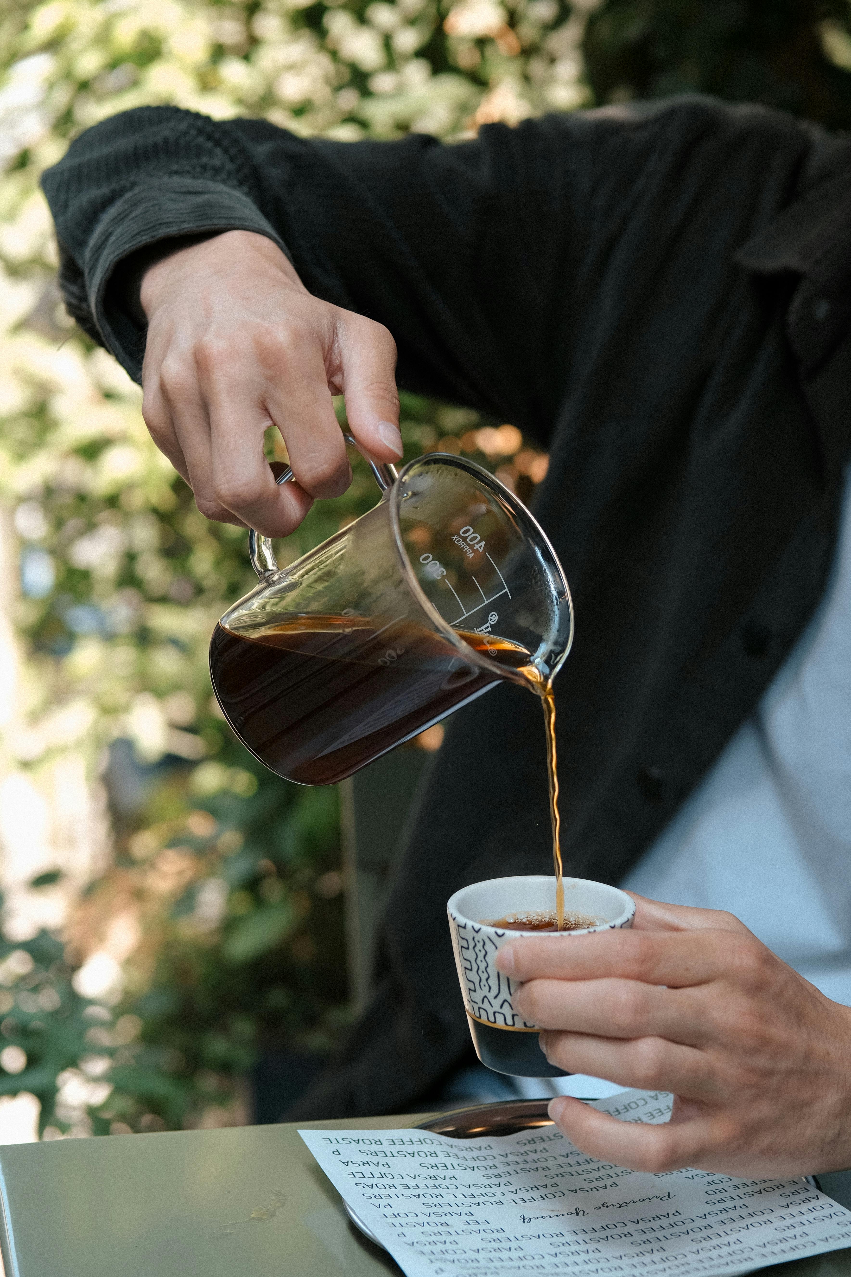 man pouring a cup of turkish tea