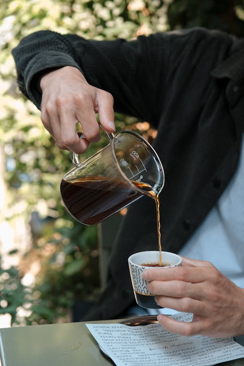 A man pouring coffee into a cup