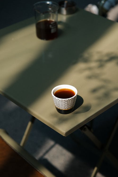 A cup of coffee sits on a table