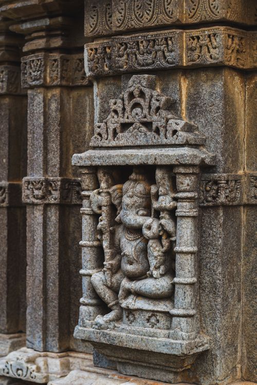 Free Detailed stone carving of Ganesha deity in an Indian temple, showcasing traditional Hindu art and architecture. Stock Photo