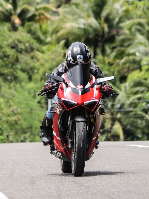 Free A thrilling ride on a red Ducati through lush Philippine scenery, capturing adventure and speed. Stock Photo