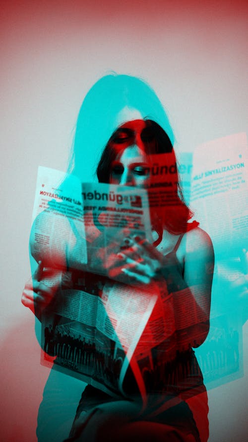 A woman is holding a newspaper in her hand