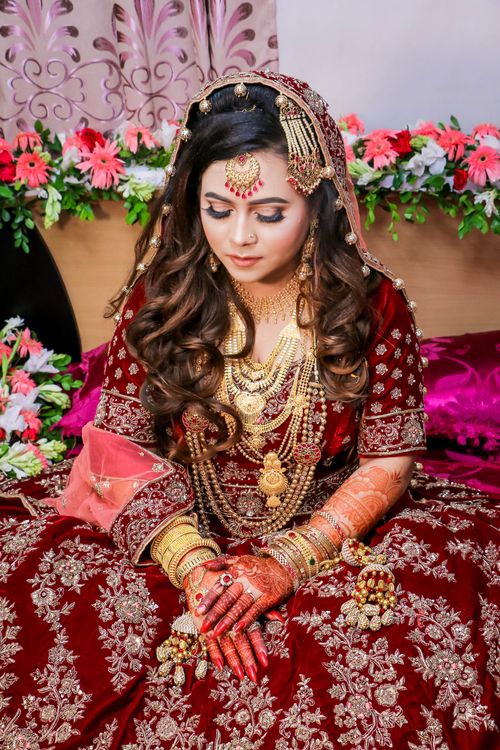 Free Elegant portrait of a bride in detailed traditional Indian wedding dress and jewelry. Stock Photo