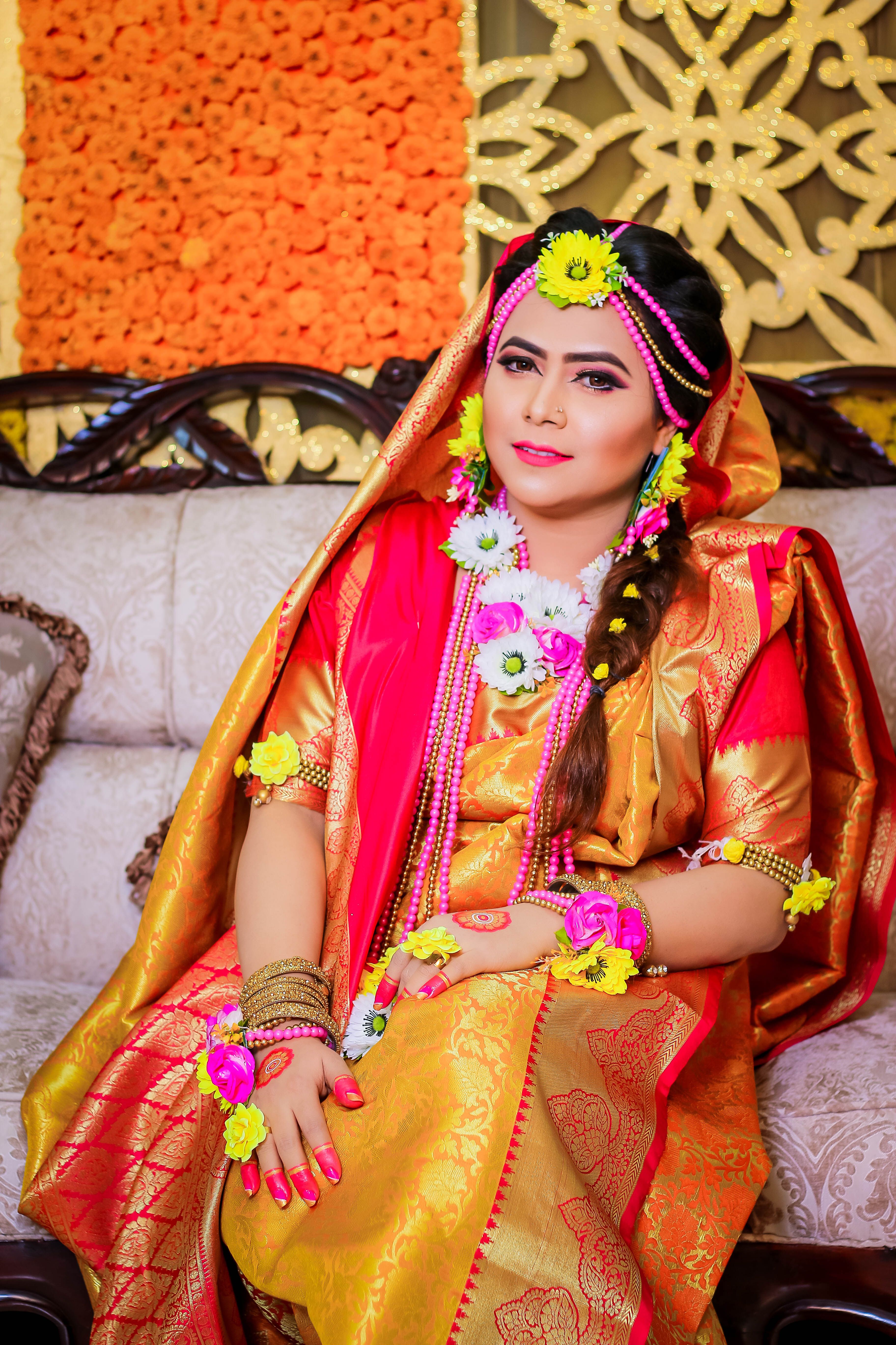 A beautiful woman in traditional indian attire sitting on a couch ...