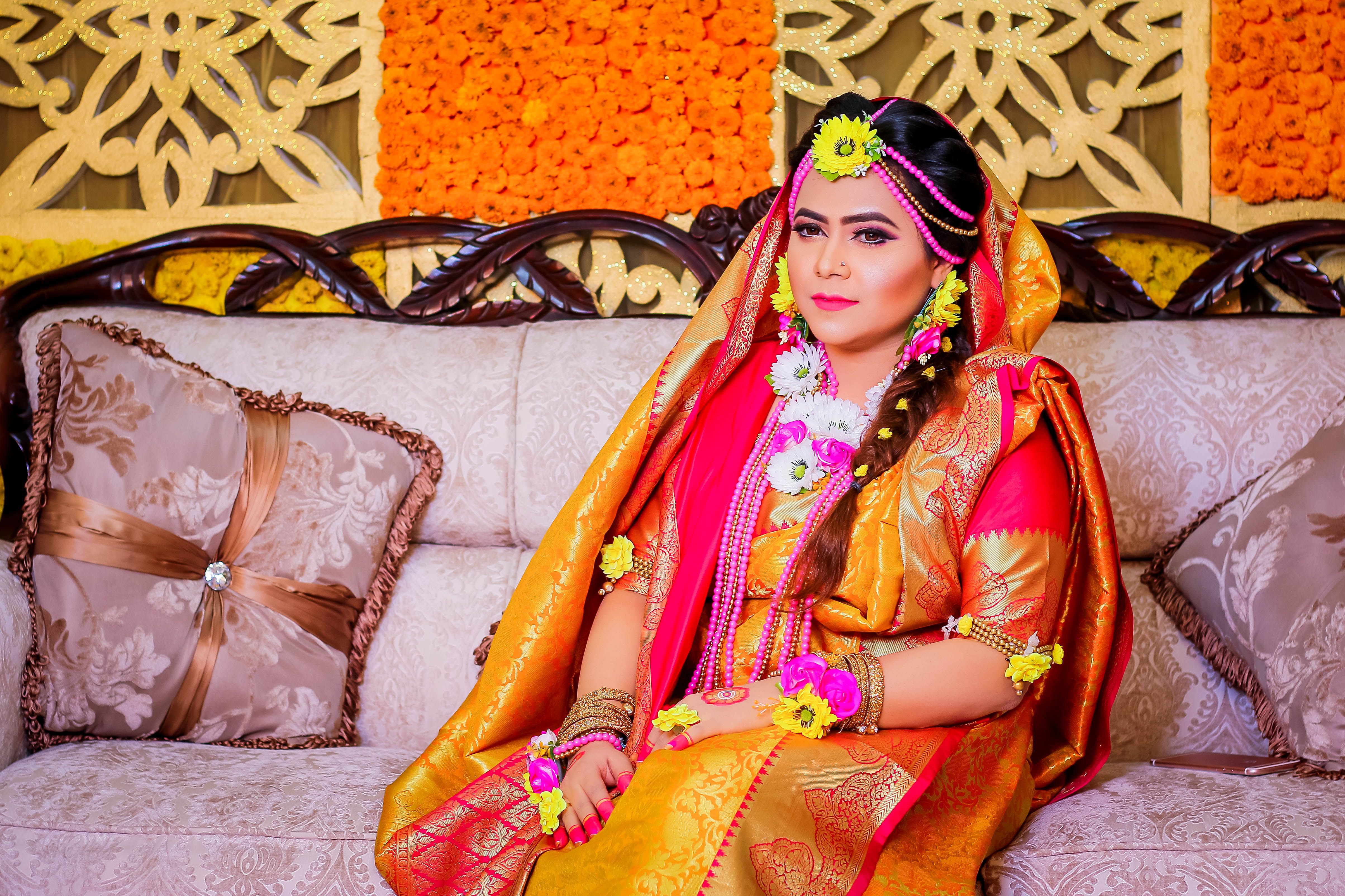 Woman in Traditional Clothing Sitting on Couch · Free Stock Photo