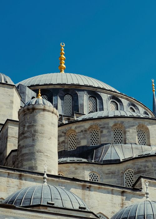 Free Close-up of the domes of Istanbul's Blue Mosque under a clear blue sky. Stock Photo