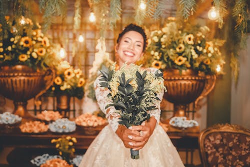 A bride holding a bouquet of sunflowers