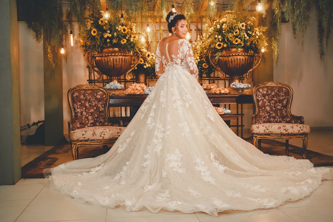 Free Back View of a Woman in a Wedding Dress Glancing Stock Photo