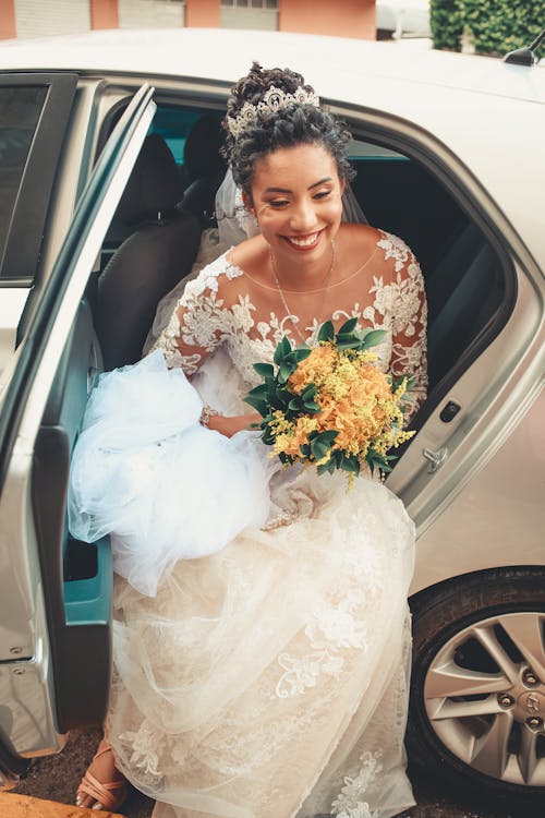 A bride is getting out of her car
