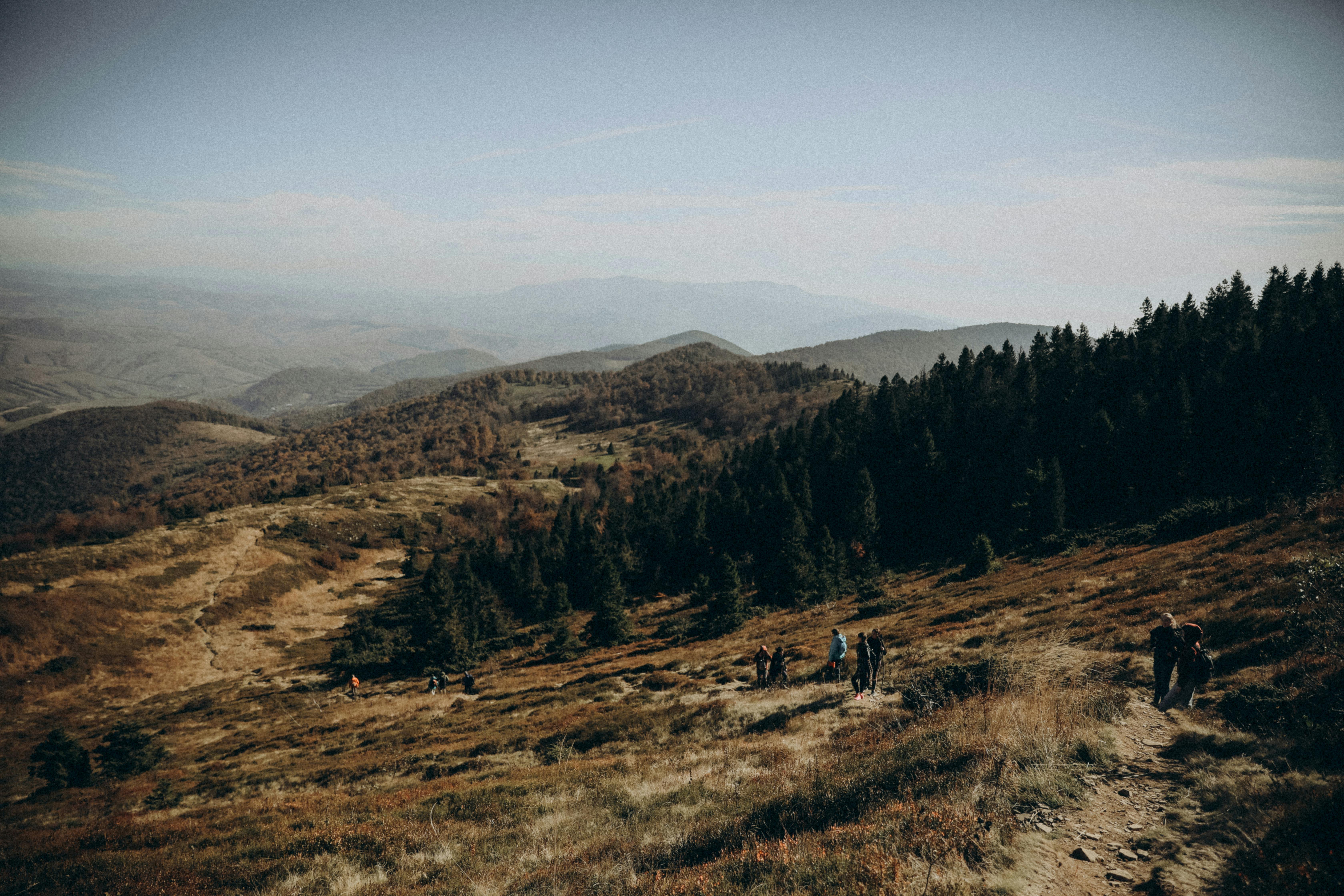 People hiking on a mountain trail in the mountains