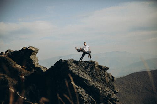 A man is standing on top of a mountain