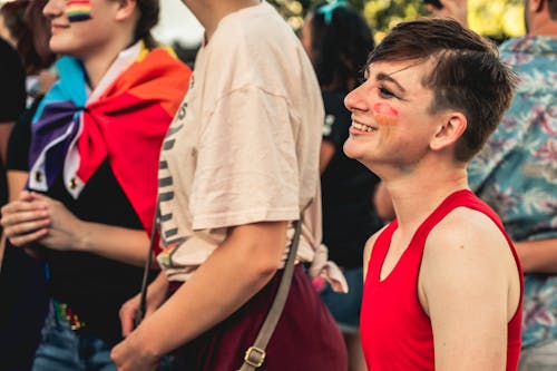 Smiling Person Wearing Red Tank Top With Face Paint