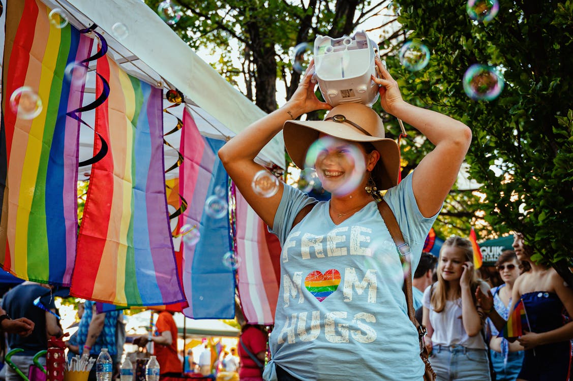 Photo of a Smiling Woman Holding Device on Head so fragrance