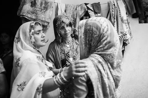 A black and white photo of two women in traditional clothing