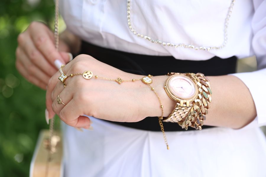 Woman's wrist with elegant gold jewelry