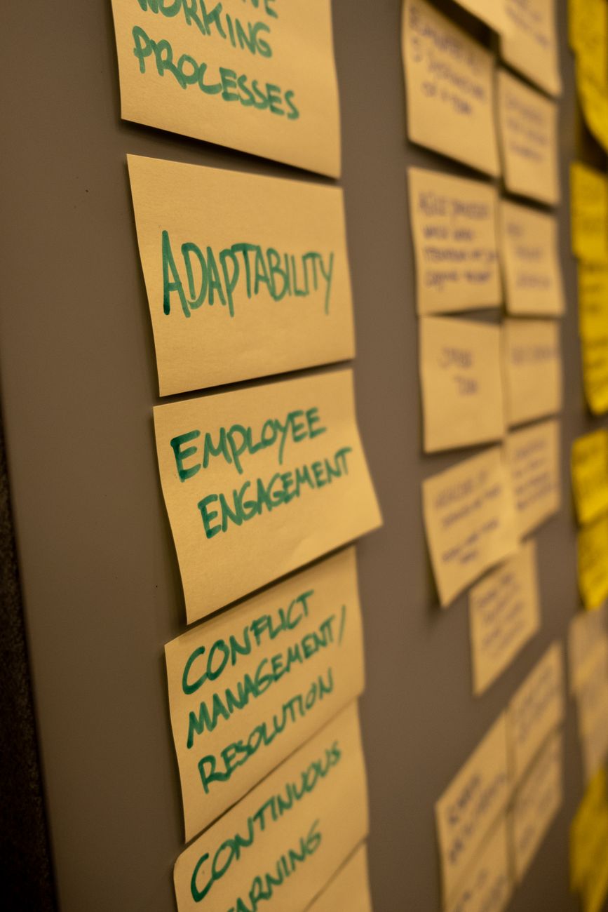 Sticky notes and planning cards arranged on a wall to map project phases