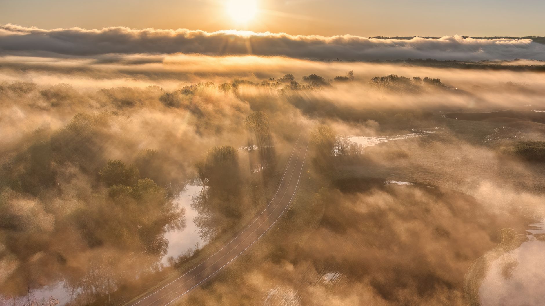 Misty sunrise with clouds and sun rays over Wabasha, MN. Tranquil aerial landscape.