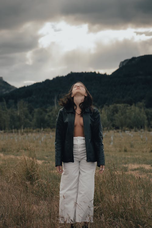 A woman standing in the middle of a field