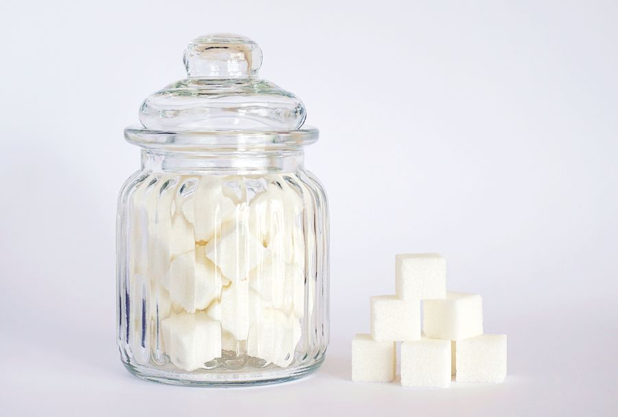 Close-up of white sugar cubes in a glass jar
