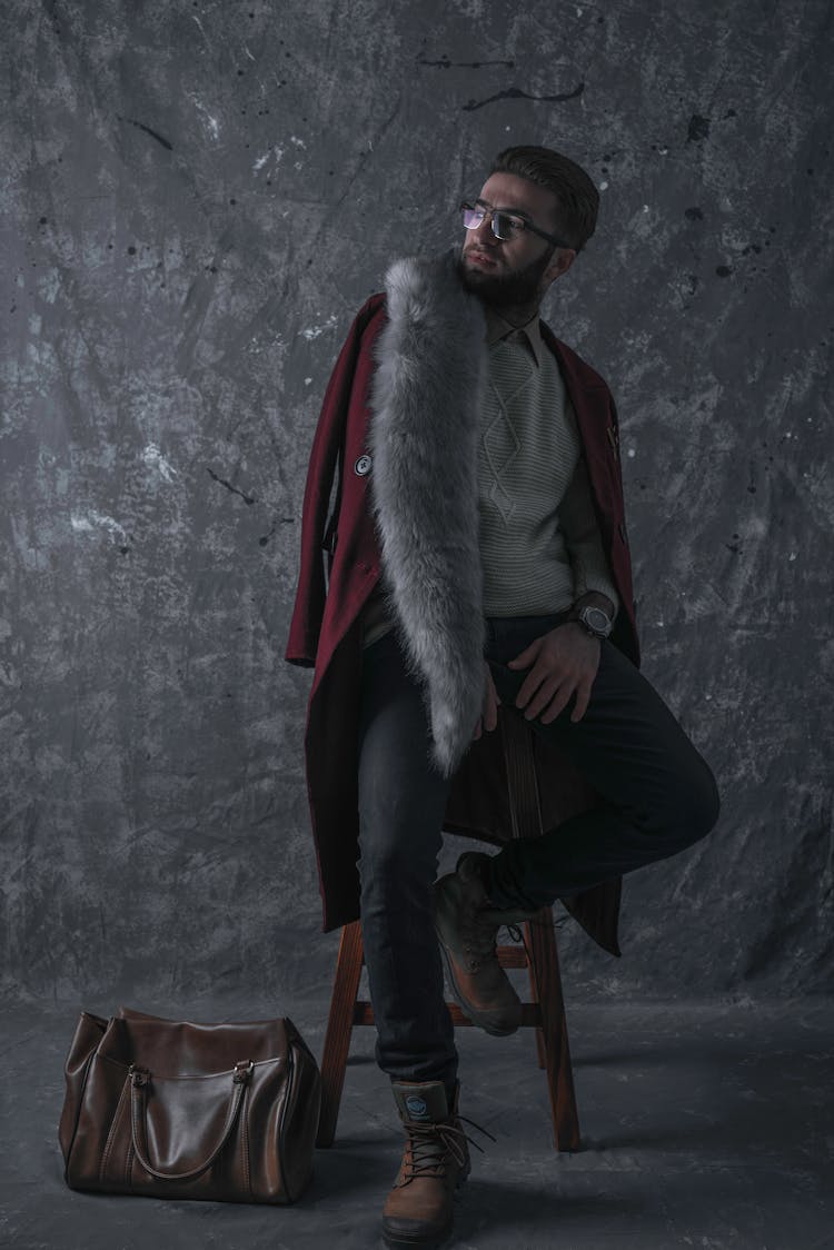 Photo Of Man Sitting On Stool