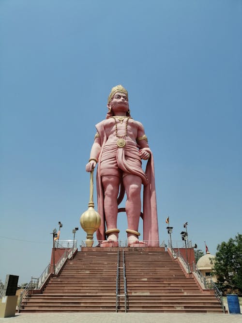 A large statue of a man standing on top of stairs