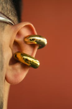 Detailed closeup of a golden hoop earring on an ear shot in Bogotá studio.