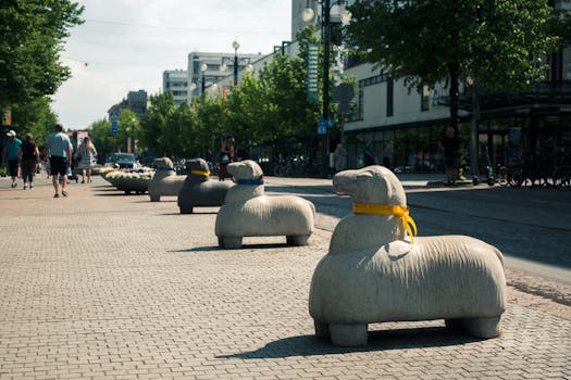 Sheep sculptures line the streets of Lahti, Finland, providing an artistic urban vibe on a sunny day.