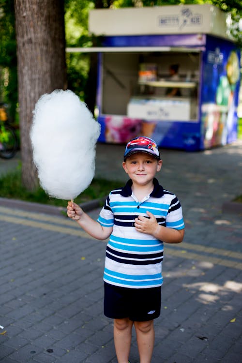 Boy Holding Cotton Candyat the Park 