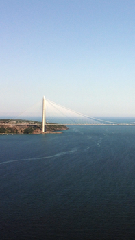 A stunning aerial view of the Bosphorus Bridge over the blue waters of Istanbul.