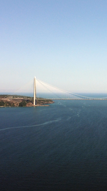 A stunning aerial view of the Bosphorus Bridge over the blue waters of Istanbul.