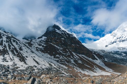 Free Breathtaking view of a snow-covered mountain peak in the Himalayas, Nepal under a bright blue sky. Stock Photo