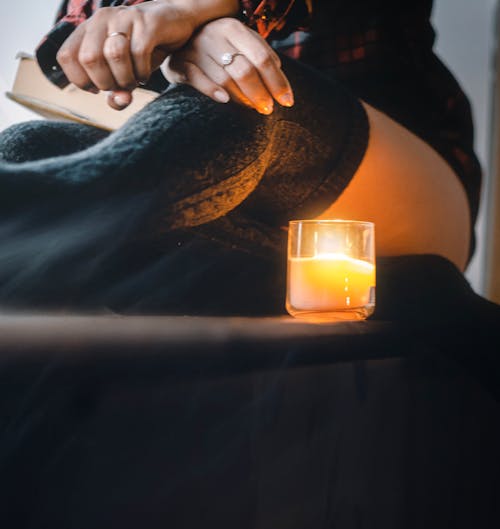 Free Person Sitting Near Candle Stock Photo