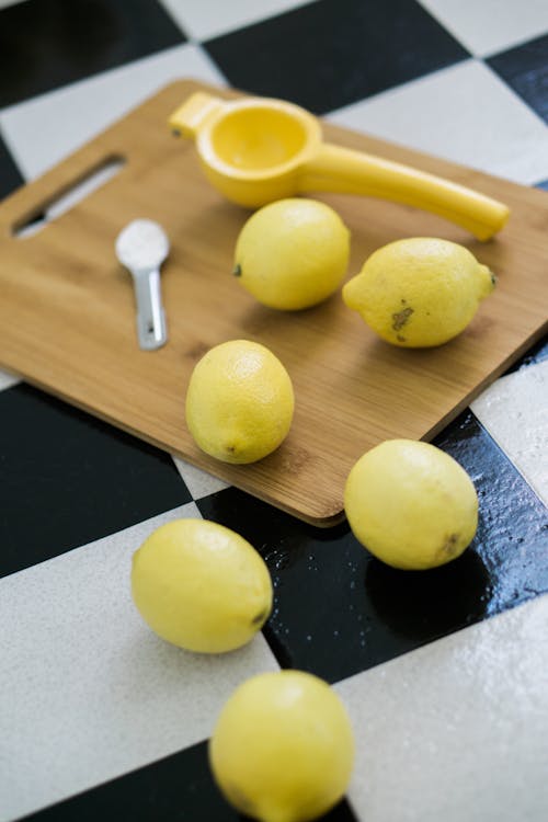 Free Yellow Lemons On Brown Wooden Chopping Board Stock Photo