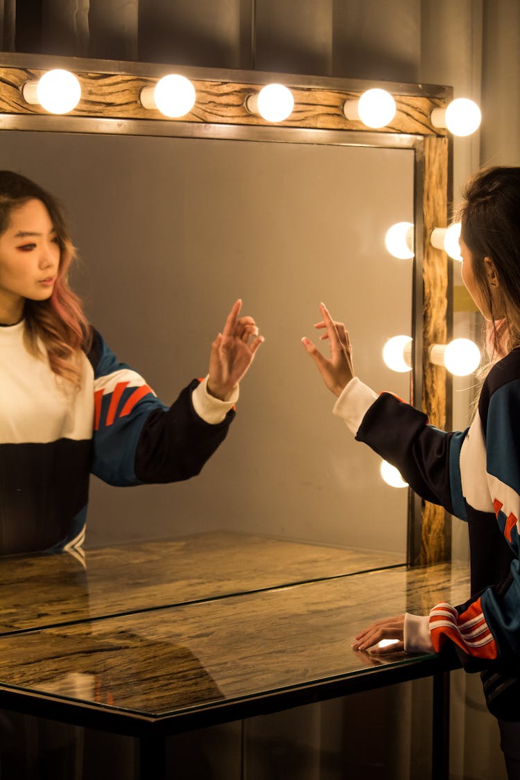 Woman In Front Of Vanity Mirror