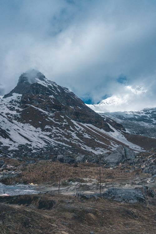Free Snowy mountain peak in the Himalayas under a cloudy sky, perfect for adventure travel imagery. Stock Photo
