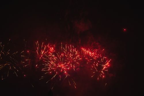 Free Dazzling red fireworks explosion lighting up the night sky, creating an exciting spectacle. Stock Photo