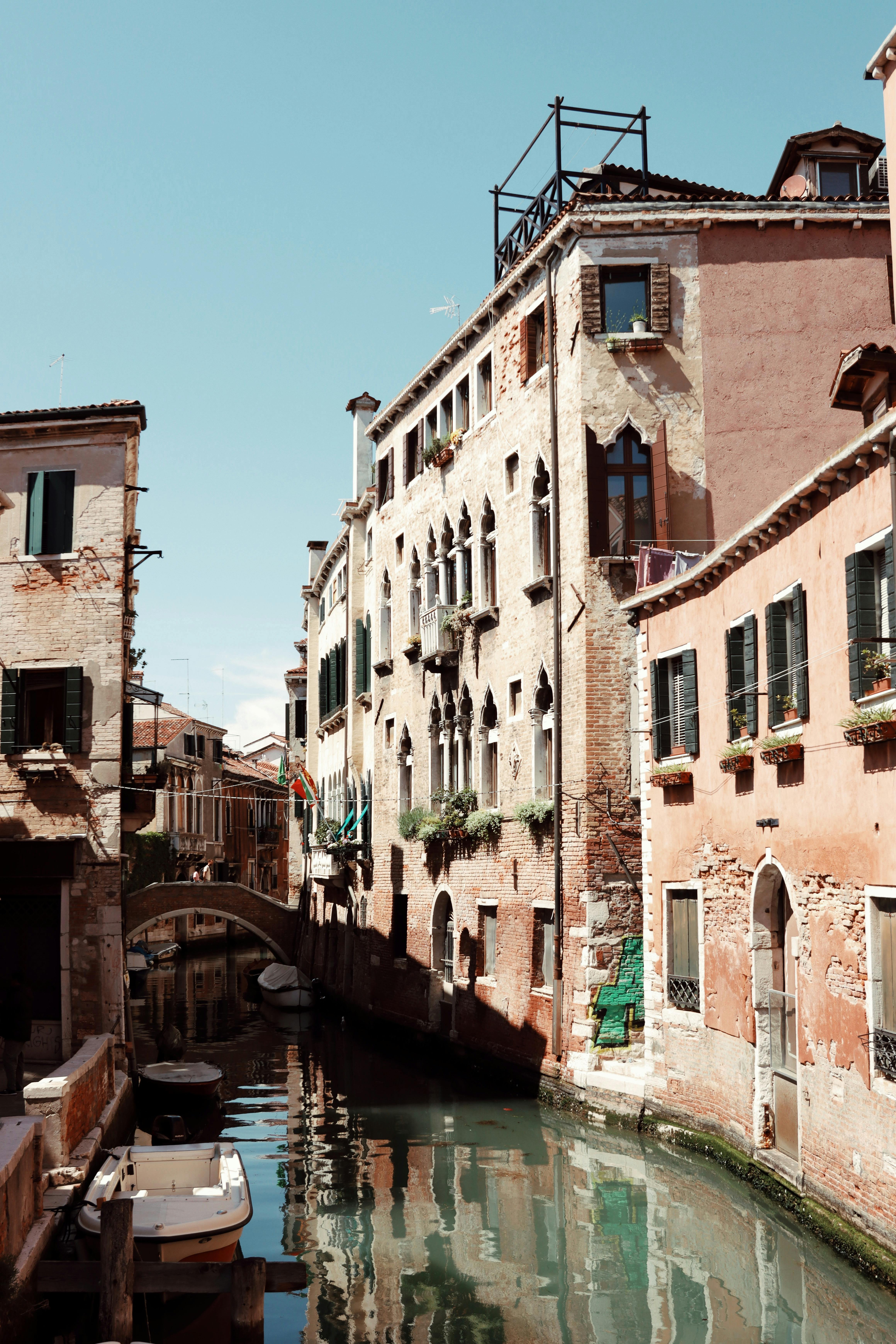 Explore the timeless beauty of Venice with a view of its historic canal and architecture.