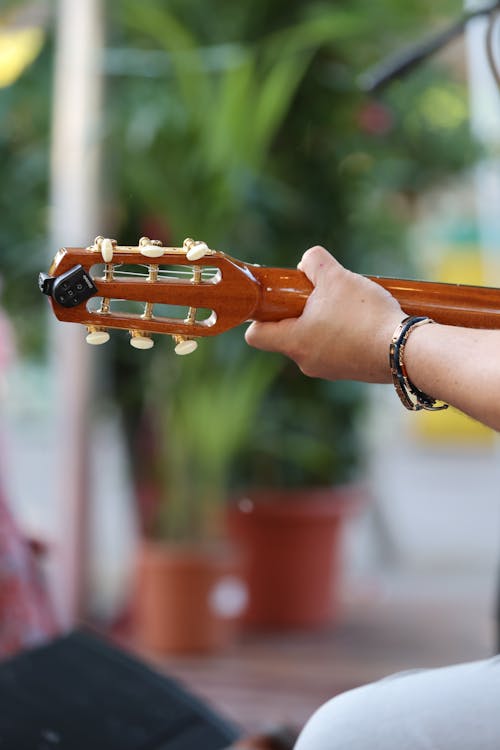 A person holding a guitar in their hand