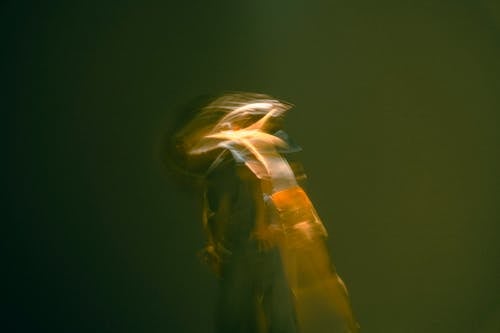 A blurry image of a person playing a violin