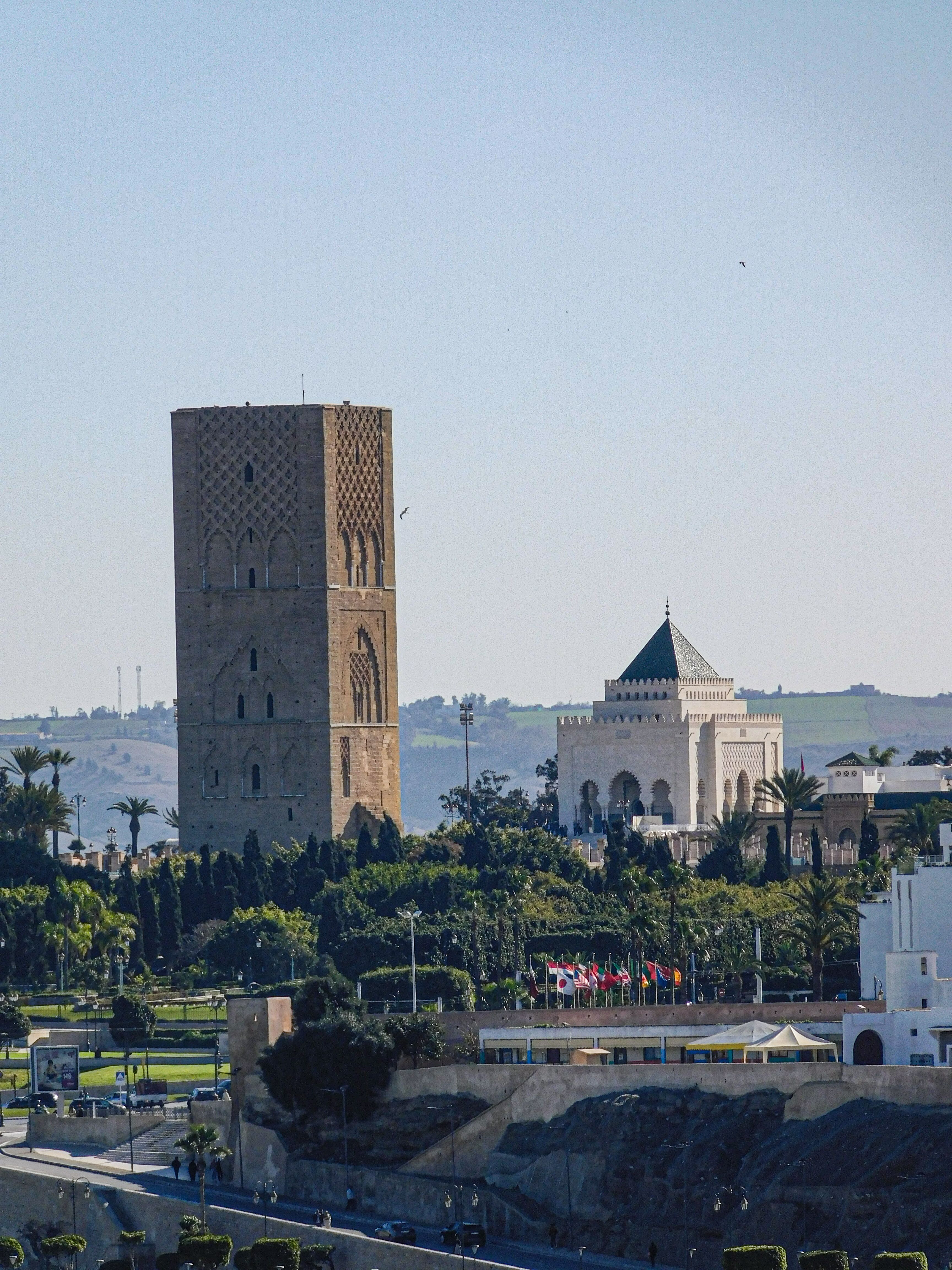 View of Hassan Tower and Mausoleum of Mohammed V in Rabat, Morocco under a clear sky.