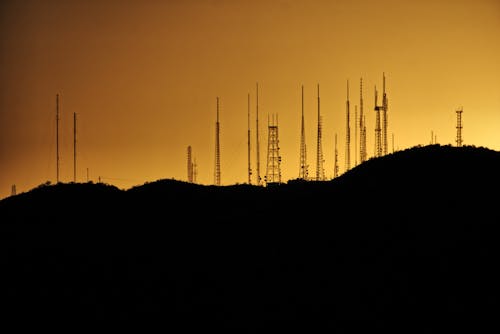 Free Silhouette Photo of Transmission Tower on Hill Stock Photo