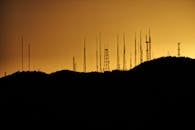 Silhouette Photo of Transmission Tower on Hill
