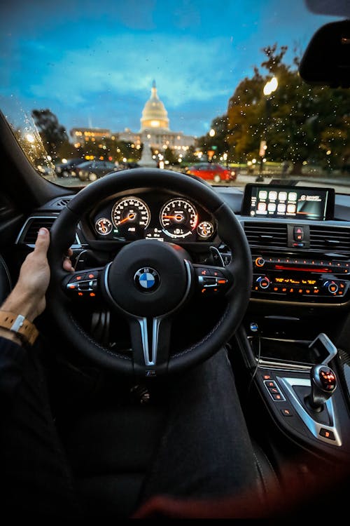 Free Person Holding Bmw Steering Wheel Stock Photo